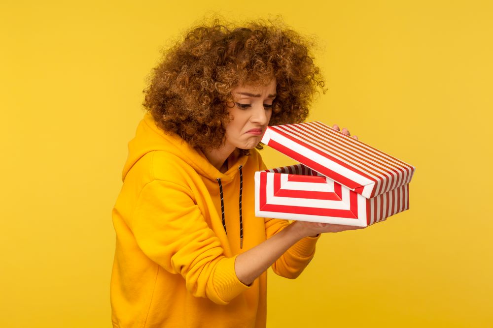 disappointed woman looking in gift box