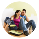 couple smiling while painting new home