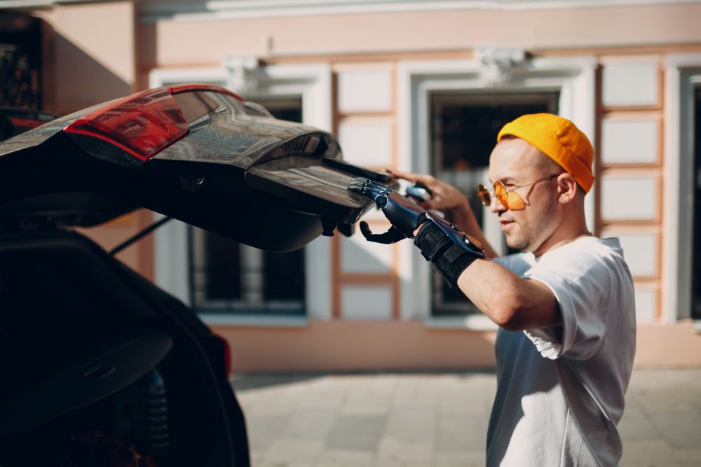 man with prosthetic hand closing trunk